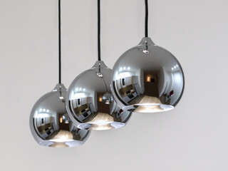 Modern designed ball lamps in a row with reflection on it, with white background, 