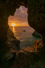 Sunset from cave in north Tenerife with view on sun and ocean
