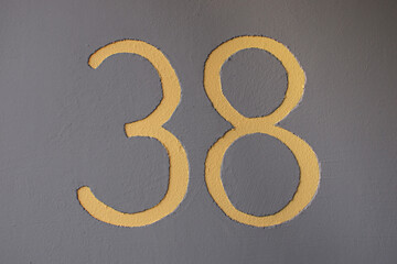 house number 38 in yellow on gray