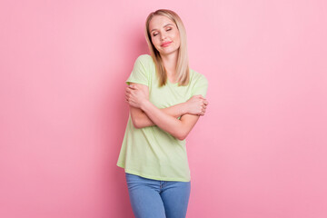 Photo of affectionate romantic lady hands hug shoulders close eyes wear green t-shirt isolated on pink background