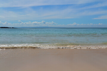 Fototapeta na wymiar summer sea waves on the beach with blue sky