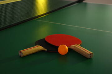 Rackets and ball on ping pong table