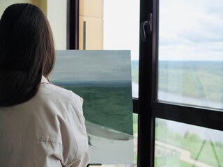 Woman Artist painting abstract oil painting in art studio. Close up photo paint brush in hand on...