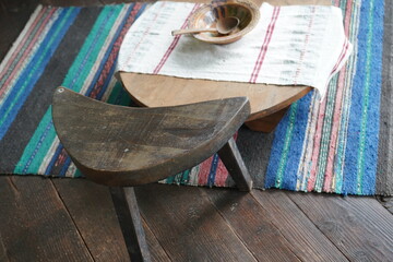 A chair and a dining table with a wooden bowl with a spoon in a Bulgarian country house from the...
