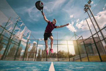 padel player playing a match in the open - obrazy, fototapety, plakaty