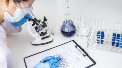 Fototapeta premium Scientist working with microscope for vaccine development in pharmaceutical research laboratory. Innovation Concept.
