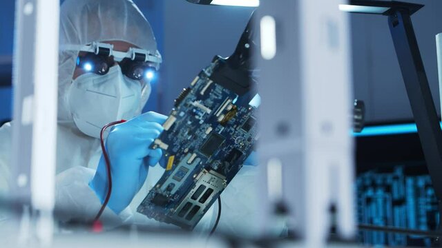 Professional engineer is developing a modern microprocessor in a futuristic laboratory using technology and computer software. Inventions and science concept.