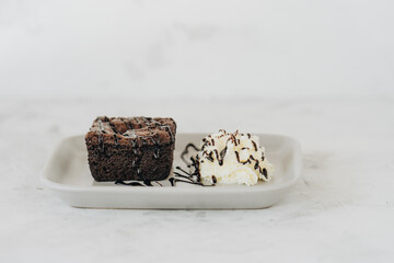 Brownie with whipped cream on a plate