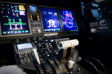 A typical dashboard panel in the cockpit of a private jet plane aircraft. Throttle control lever in...