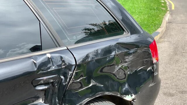 Huge dent on car after crash outdoors