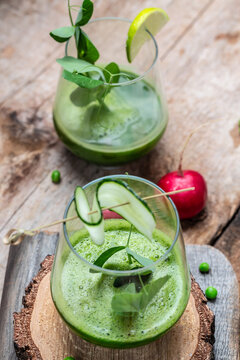 Fresh Juice Smoothie Made with Organic Greens, peas, cucumber, radish, spinach and lime. vertical image. top view