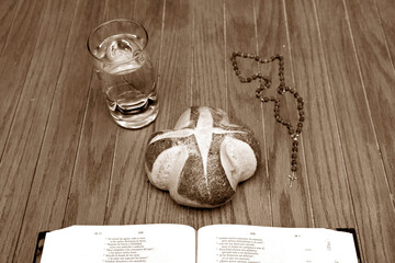Bread, water, Bible, Rosary, fasting symbols.