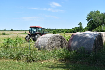 Hay Bales and a Tractor in a Field