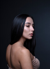 Fototapeta premium portrait of a young woman in the studio on a dark background