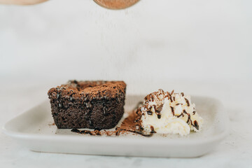 Brownie with whipped cream on a plate