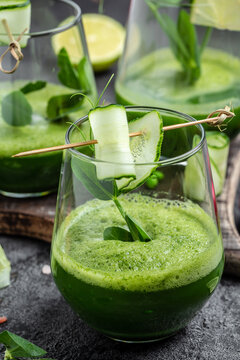 Healthy green smoothie with fresh peas, cucumber, spinach and lime, vertical image. top view
