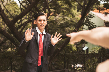 A young university student denies accusations made against him. The pointing hand of the accuser...