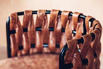 The metal chair woven with soft leather. Selective focus image