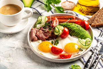 Healthy nutritious paleo keto breakfast diet Fried eggs, bacon, avocado, cheese and fresh salad. Keto breakfast or lunch. Delicious balanced food concept