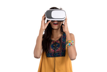 Beautiful girl looking though VR device. Young girl wearing virtual reality goggles headset.