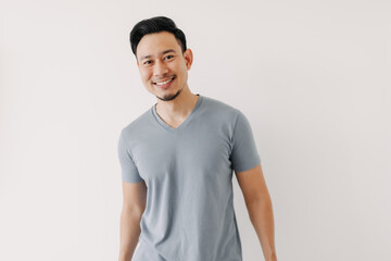 Portrait of happy Asian man in blue t-shirt isolated on white background.