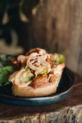 Toast with crispy fried spicy chicken, onion and sause
