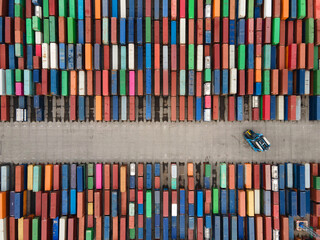 industrial robot working with shipping containers in the port
