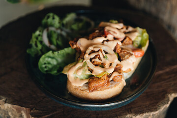 Toast with crispy fried spicy chicken, onion and sause