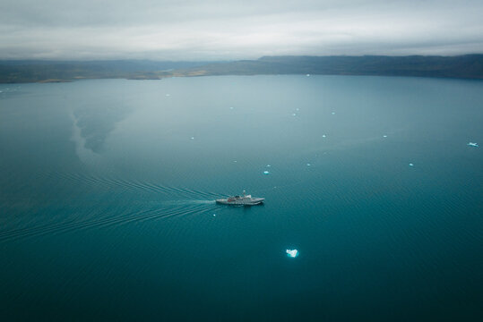 Warship floating on calm sea water
