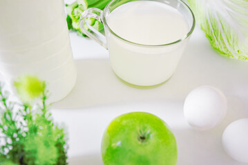set of products for healthy eating white and green layout on the kitchen table.