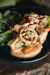 Toast with crispy fried spicy chicken, onion and sause