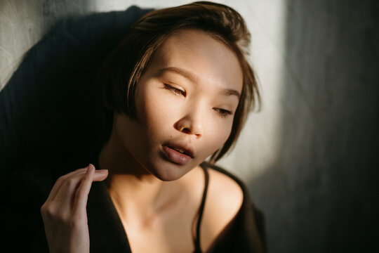 Asian young woman in a dark room.