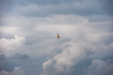 Unmanned aircraft drone flies in the cloudy sky / plane flies