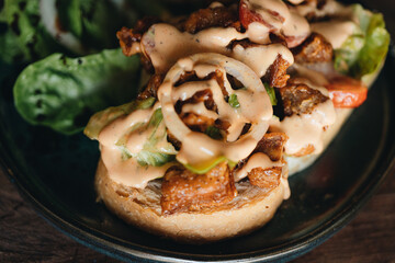 Toast with crispy fried spicy chicken, onion and sause