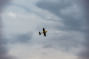 Unmanned aircraft drone flies in the cloudy sky / plane flies