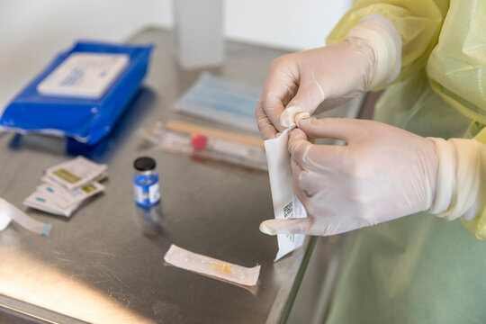 A nurse opening up sterilized 