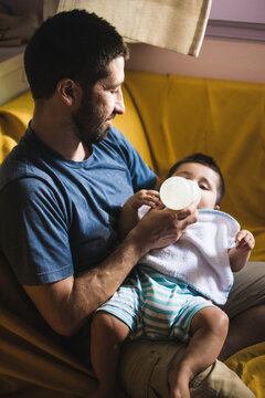 Father And Baby Boy Bonding Over Feeding Time