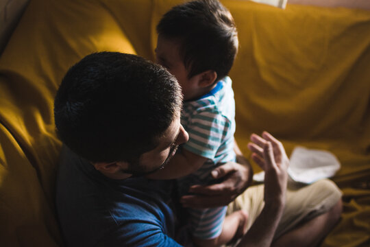 Father soothing his baby who is crying