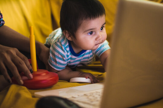 Baby looking at computer screen up close