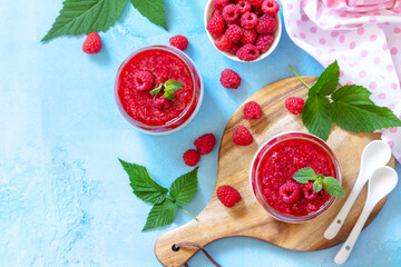 Italian dessert. Raspberry Panna cotta with raspberry jelly on a stone or concrete background,...