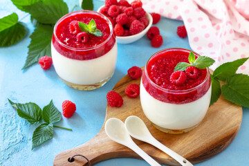 Italian dessert. Raspberry Panna cotta with raspberry jelly on a stone or concrete background, homemade cuisine.