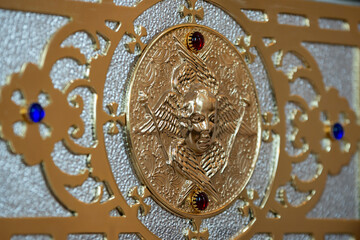 Bas-relief with an angel in gold / golden angel