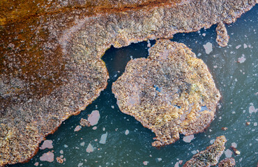 Rough shore of fast river in daylight