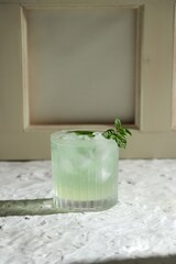green mint cocktail glass with ice