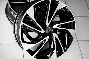 Black alloy wheels on a car, close-up. Purchase and replacement of autodisks