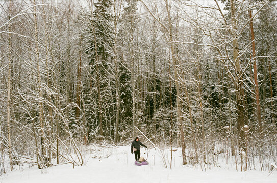Father pulls baby on tubing