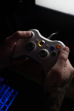 Crop man playing videogame at night