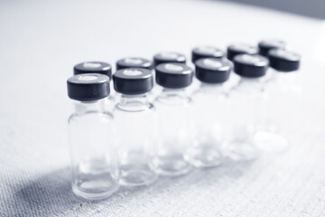 Empty glass jars of coronavirus vaccines
