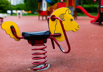 children's swing in the playground in the form of a horse