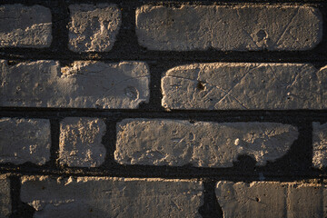 Brick background. Brickwork illuminated by side sunlight. 